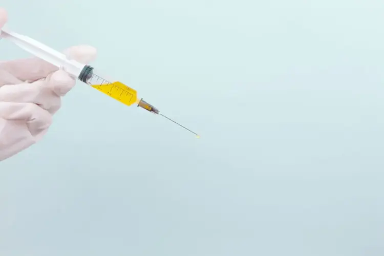 Bryan Johnson holding a syringe to take a peptide